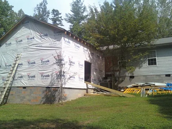 Tyvek wrapped gable on a new room addition beside an existing home in Henrico